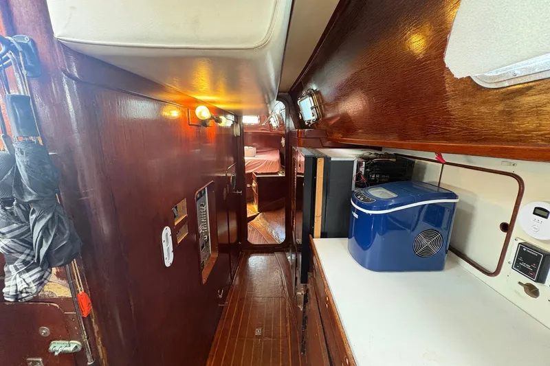 Slide: The Image of Interior of 1980 Gulfstar 50 CC Ketch with wooden cabinetry and modern appliances. - 26