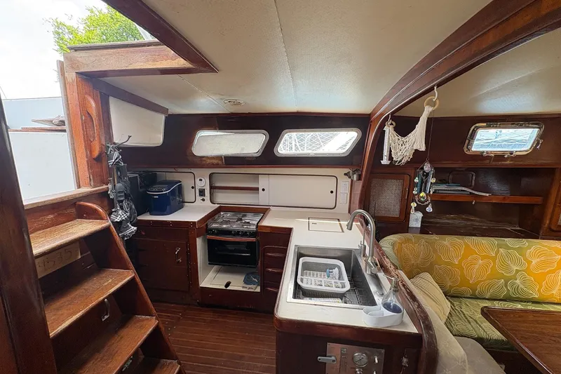 Slide: The Image of Interior of 1980 Gulfstar 50 CC Ketch, featuring a cozy kitchen and seating area. - 22