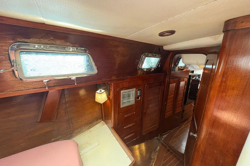 Slide: The Image of Interior of 1980 Gulfstar 50 CC Ketch, featuring wooden paneling and portholes. - 34