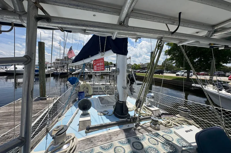 Slide: The Image of 1980 Gulfstar 50 CC Ketch sailboat docked, featuring deck view and "For Sale" sign. - 10