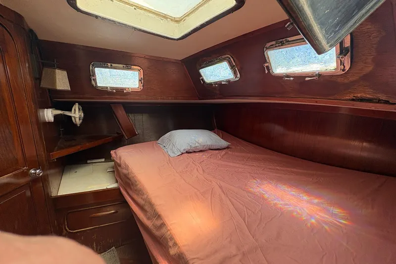 Slide: The Image of Cozy cabin interior of 1980 Gulfstar 50 CC Ketch with wooden finish and porthole windows. - 32
