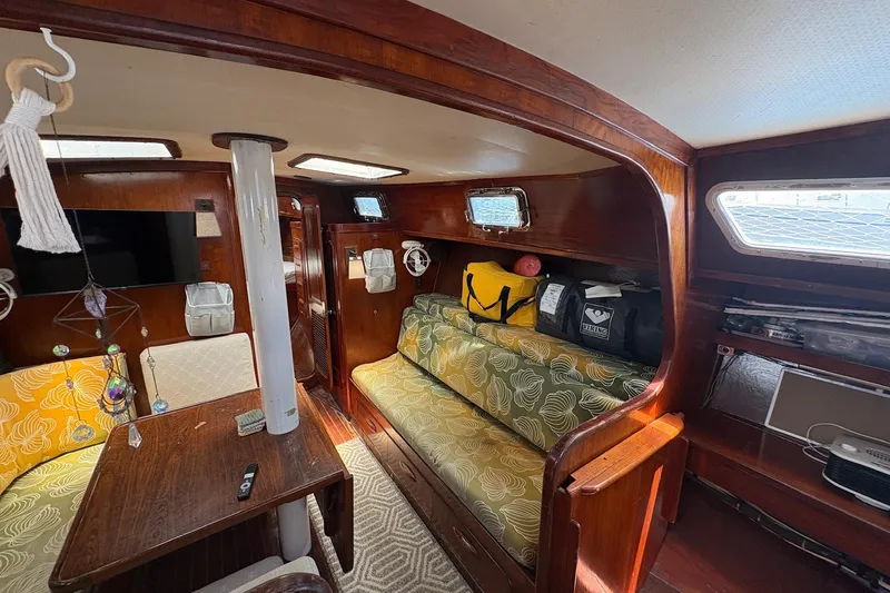 Slide: The Image of Interior of 1980 Gulfstar 50 CC Ketch with wooden furnishings and cozy seating area. - 41