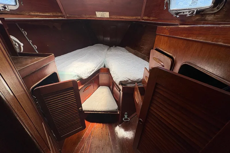 Slide: The Image of Cozy cabin interior of 1980 Gulfstar 50 CC Ketch with wooden furnishings and twin beds. - 47
