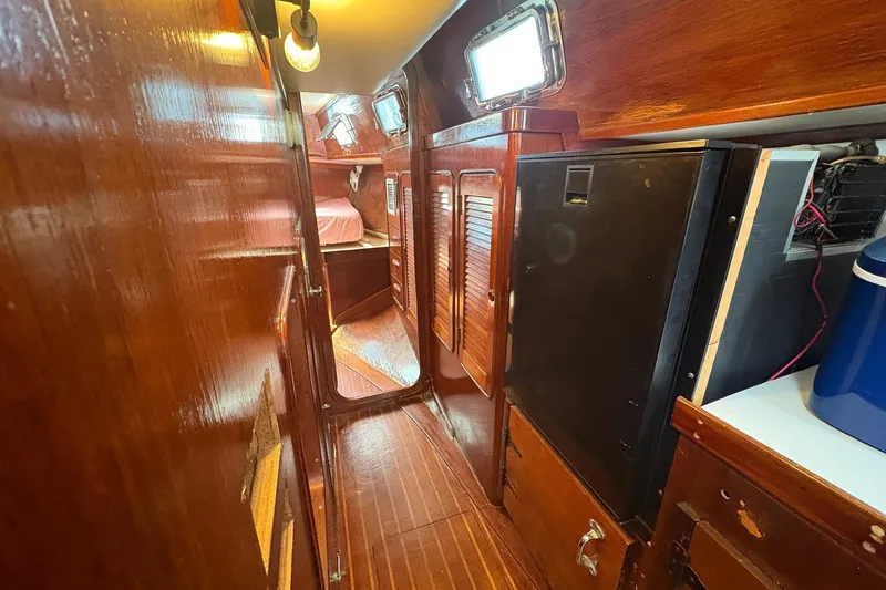 Slide: The Image of Interior of 1980 Gulfstar 50 CC Ketch, featuring wooden cabinetry and cozy sleeping quarters. - 27
