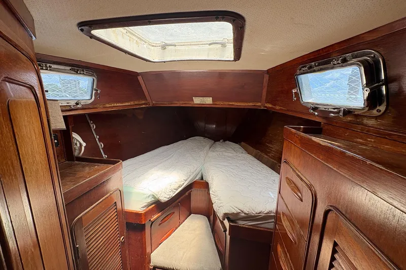 Slide: The Image of Cozy cabin interior of 1980 Gulfstar 50 CC Ketch with wooden furnishings and twin beds. - 42
