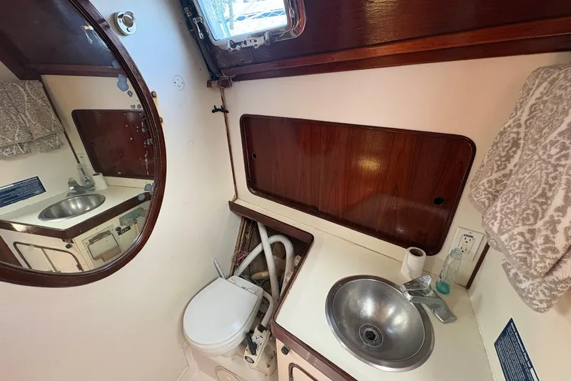 Slide: The Image of 1980 Gulfstar 50 CC Ketch bathroom with sink, toilet, and mirror. - 37