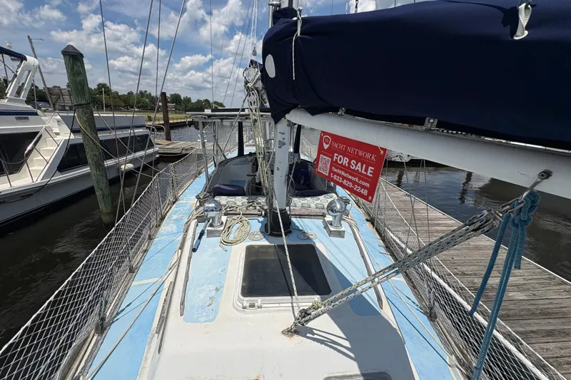 Slide: The Image of 1980 Gulfstar 50 CC Ketch sailboat docked, featuring a "For Sale" sign on deck. - 8