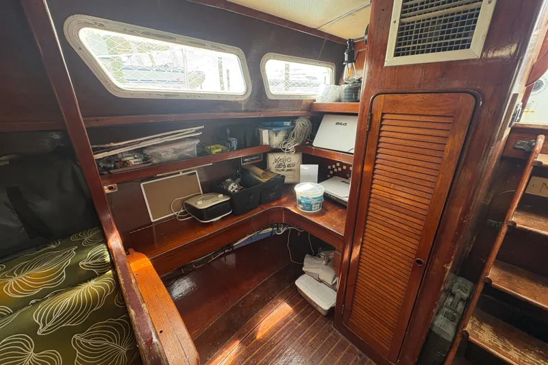 Slide: The Image of Interior of 1980 Gulfstar 50 CC Ketch with wooden shelves and nautical equipment. - 21