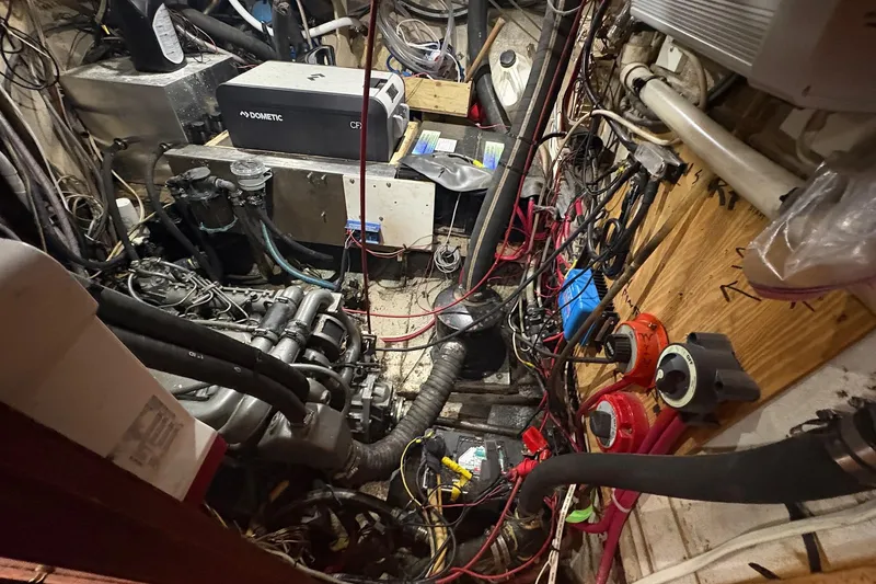 Slide: The Image of Engine room of a 1980 Gulfstar 50 CC Ketch with visible wiring and machinery. - 44