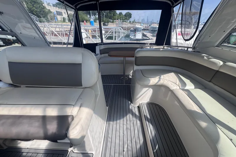 Slide: The Image of Interior of a 2003 Rinker Fiesta Vee 312 boat with spacious seating and dock view. - 11