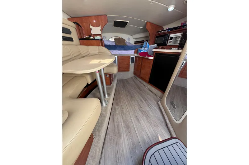 Slide: The Image of Interior of 2003 Rinker Fiesta Vee 312 boat with seating and kitchenette. - 17