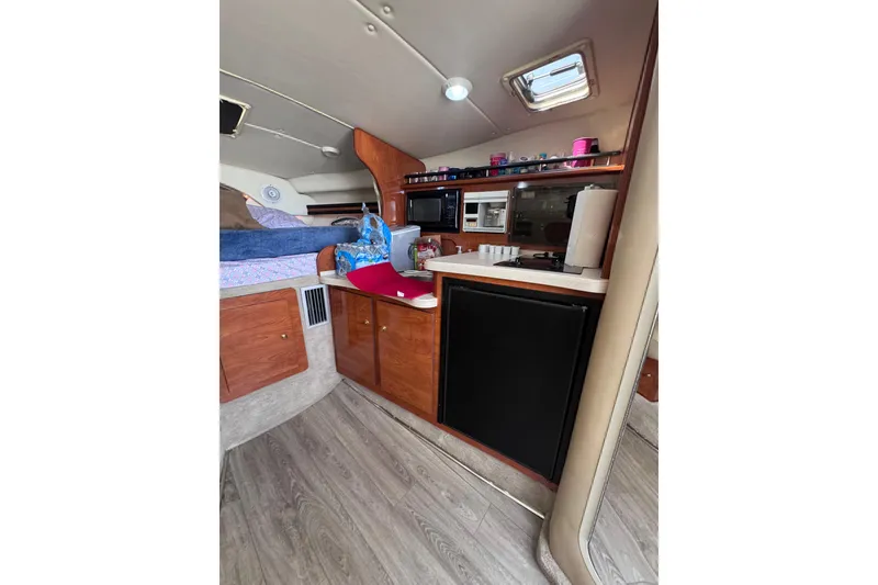 Slide: The Image of 2003 Rinker Fiesta Vee 312 cabin interior with kitchenette and sleeping area. - 25