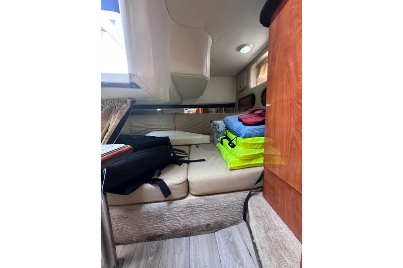 Slide: The Image of 2003 Rinker Fiesta Vee 312 cabin interior with seating and storage. - 23