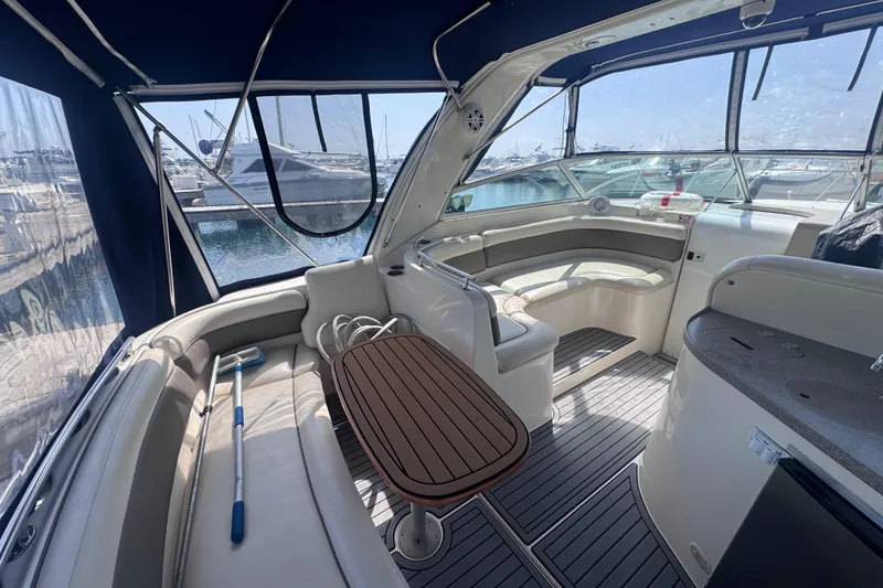 Slide: The Image of Interior of a 2003 Rinker Fiesta Vee 312 yacht with seating and table, docked at marina. - 6