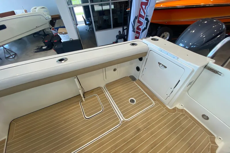 Slide: The Image of 2016 World Cat Glacier Bay Edition 2740 Dual Console boat interior with teak flooring. - 30