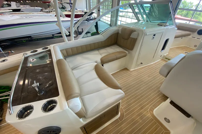 Slide: The Image of 2016 World Cat Glacier Bay Edition 2740 Dual Console interior with seating and kitchenette. - 35