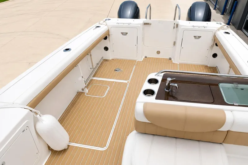 Slide: The Image of 2016 World Cat Glacier Bay Edition 2740 Dual Console boat interior with seating and sink. - 5