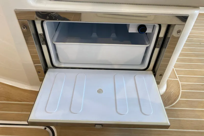 Slide: The Image of Open storage compartment on 2016 World Cat Glacier Bay Edition 2740 Dual Console boat. - 40