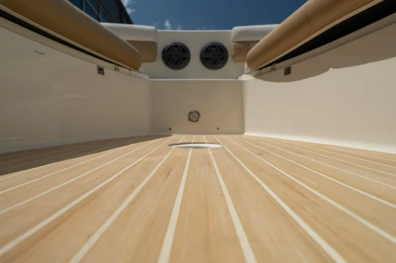 Slide: The Image of 2016 World Cat Glacier Bay Edition 2740 Dual Console boat interior with teak flooring. - 18