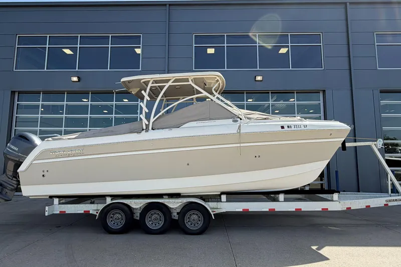 Slide: The Image of 2016 World Cat Glacier Bay Edition 2740 Dual Console boat on trailer, parked outside. - 4