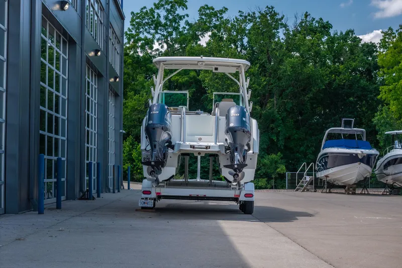 Slide: The Image of 2016 World Cat Glacier Bay Edition 2740 Dual Console boat on trailer, outdoor setting. - 21