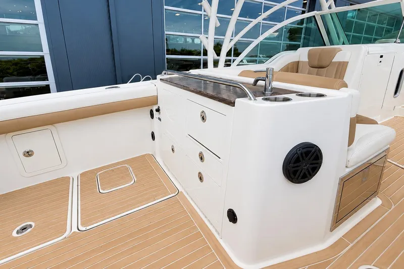 Slide: The Image of 2016 World Cat Glacier Bay Edition 2740 Dual Console boat interior with seating and storage. - 7