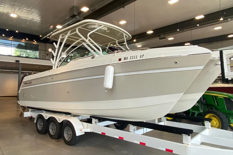 Slide: The Image of 2016 World Cat Glacier Bay Edition 2740 Dual Console boat on trailer in showroom. - 22