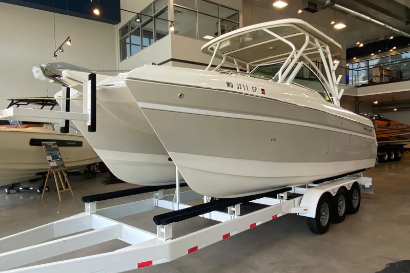 Slide: The Image of 2016 World Cat Glacier Bay Edition 2740 Dual Console boat on a trailer in showroom. - 23