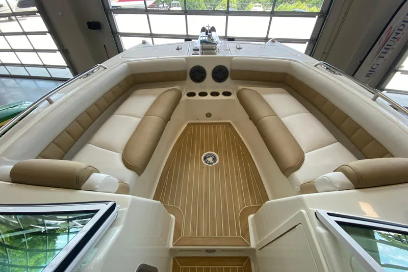 Slide: The Image of 2016 World Cat Glacier Bay Edition 2740 Dual Console boat interior with beige seating and wood flooring. - 52
