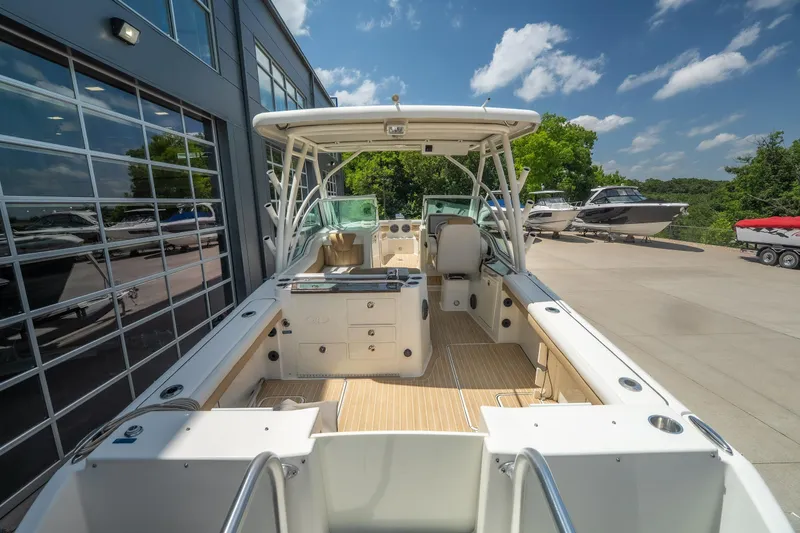 Slide: The Image of 2016 World Cat Glacier Bay Edition 2740 Dual Console boat docked outdoors. - 19