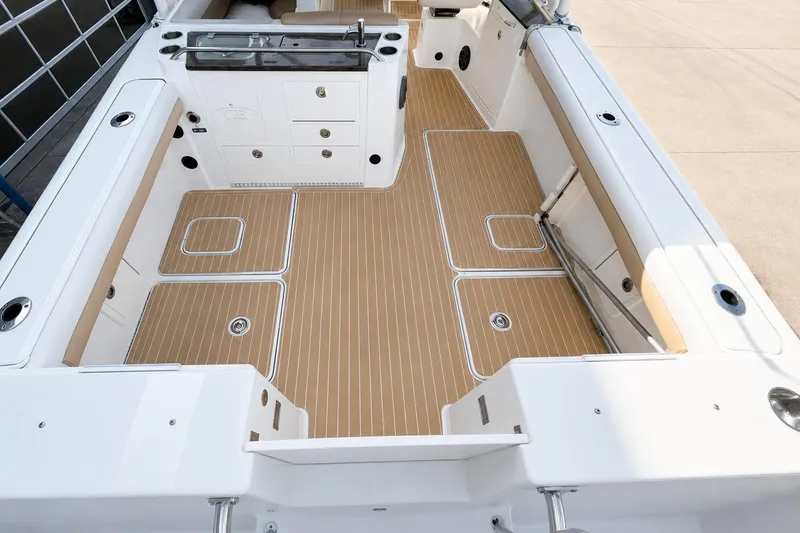 Slide: The Image of 2016 World Cat Glacier Bay Edition 2740 Dual Console boat interior with teak flooring. - 6