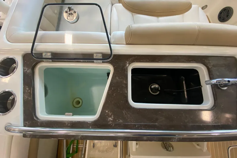 Slide: The Image of 2016 World Cat Glacier Bay Edition 2740 Dual Console boat interior with storage compartments. - 33