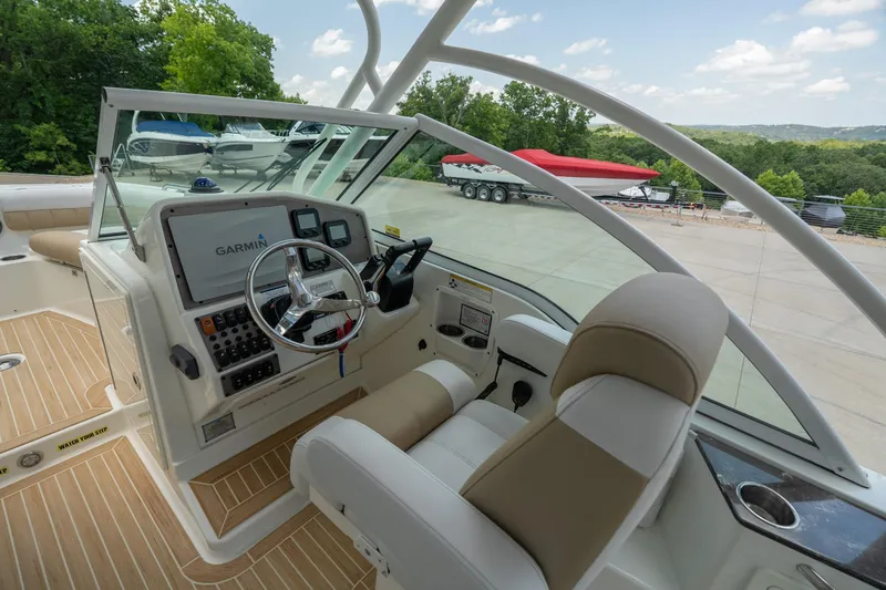 Slide: The Image of 2016 World Cat Glacier Bay Edition 2740 Dual Console boat interior with Garmin navigation system. - 11