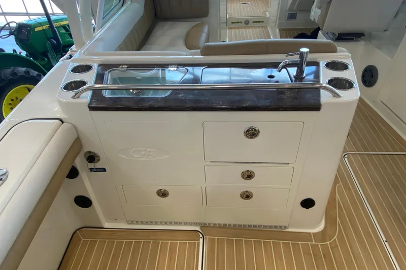Slide: The Image of 2016 World Cat Glacier Bay Edition 2740 Dual Console boat interior with sink and storage. - 28
