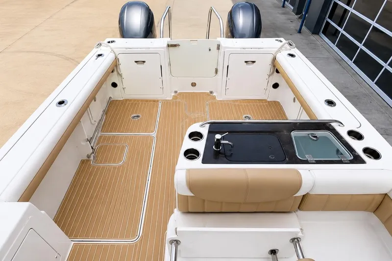 Slide: The Image of 2016 World Cat Glacier Bay Edition 2740 Dual Console boat interior with teak flooring and seating. - 8