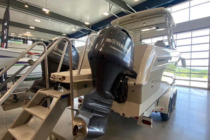 Slide: The Image of 2016 World Cat Glacier Bay Edition 2740 Dual Console boat with Yamaha engines in a showroom. - 27