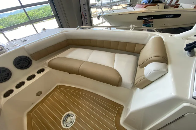 Slide: The Image of 2016 World Cat Glacier Bay Edition 2740 Dual Console interior with tan and white seating. - 54