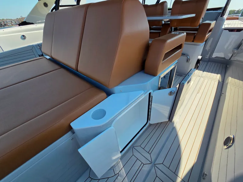 Slide: The Image of The image shows the cockpit of a 2027 Cruisers Yachts 38 VTR with brown seats and a table. - 17