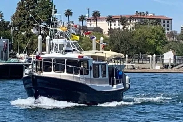 Slide: The Image of 2008 Ranger 2510 Bay Ranger boat cruising on a sunny day near a waterfront. - 1