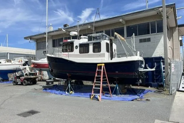 Slide: The Image of 2008 Ranger 2510 Bay Ranger boat on stands at a marina, clear sky background. - 4