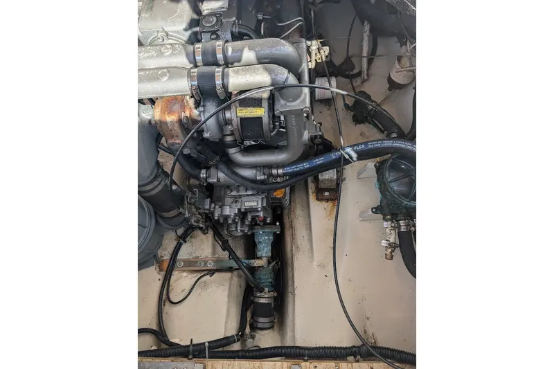 Slide: The Image of Engine compartment of a 2008 Ranger 2510 Bay Ranger boat, showing detailed components and hoses. - 43