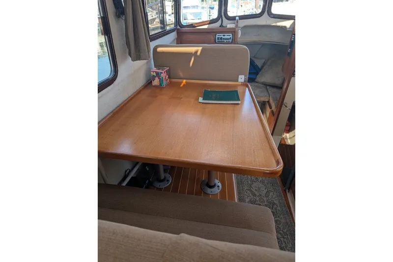 Slide: The Image of Interior of 2008 Ranger 2510 Bay Ranger boat with wooden table and seating area. - 27