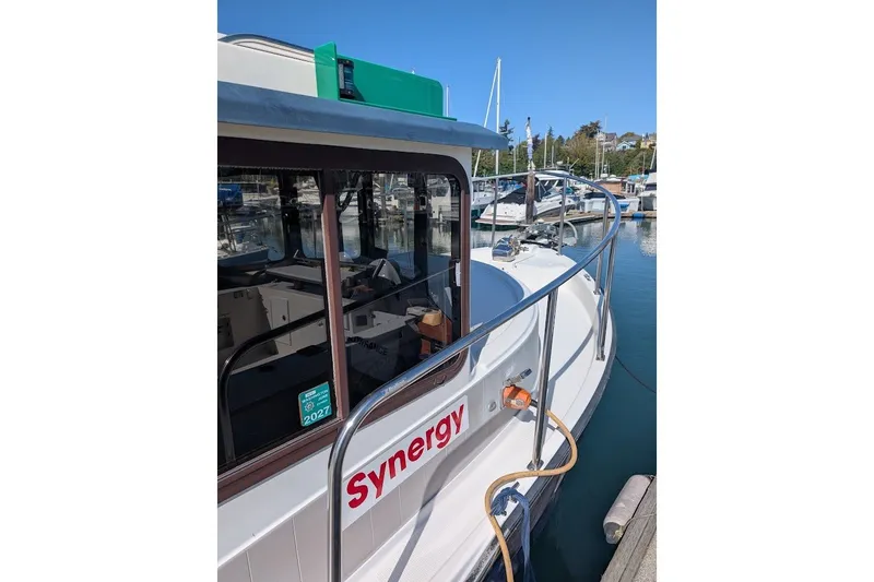 Slide: The Image of 2008 Ranger 2510 Bay Ranger boat docked at marina, labeled "Synergy." - 17