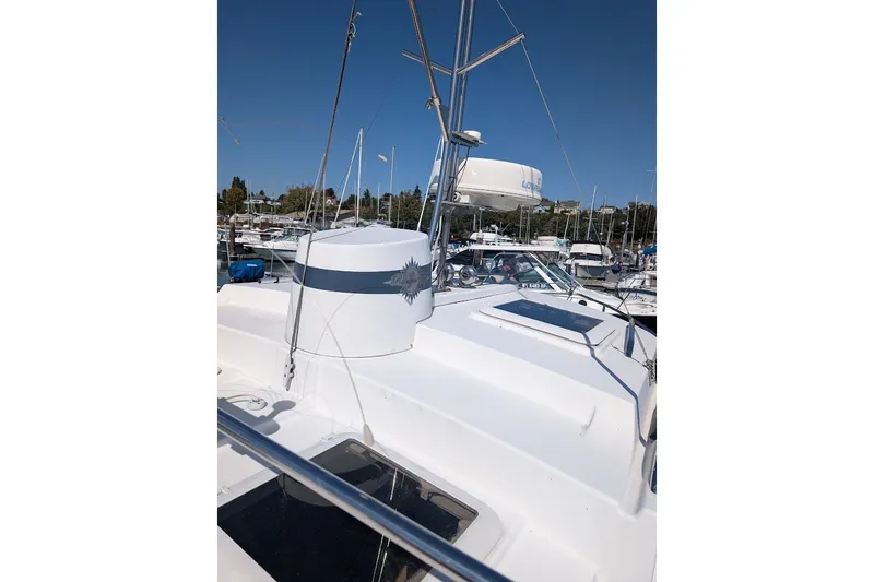 Slide: The Image of 2008 Ranger 2510 Bay Ranger boat docked at a marina under clear blue skies. - 18