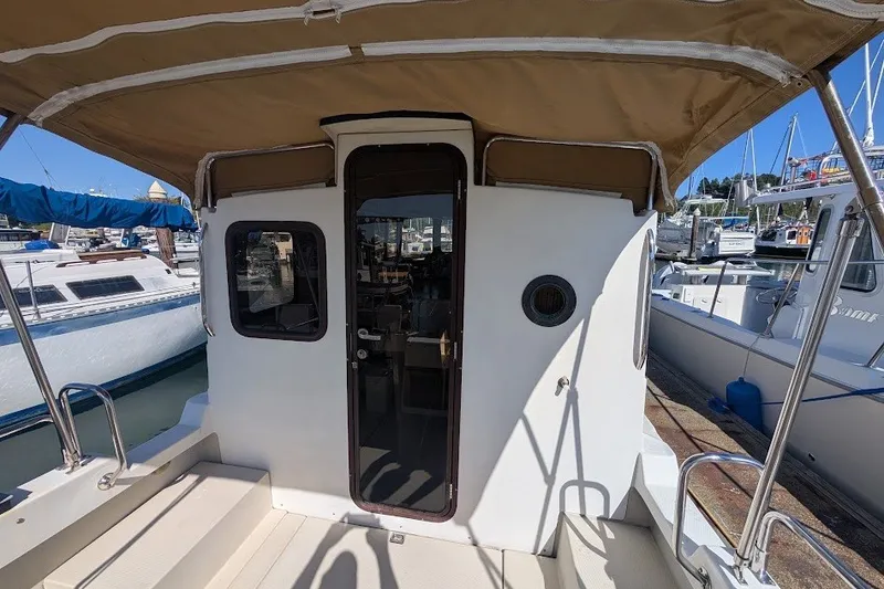 Slide: The Image of 2008 Ranger 2510 Bay Ranger boat docked at marina with canopy and cabin door. - 21