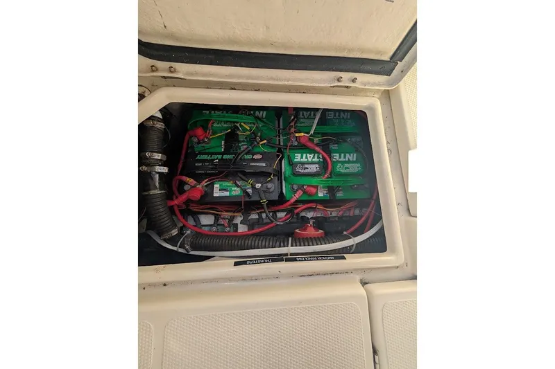 Slide: The Image of Battery compartment of a 2008 Ranger 2510 Bay Ranger boat with wiring and connections. - 47