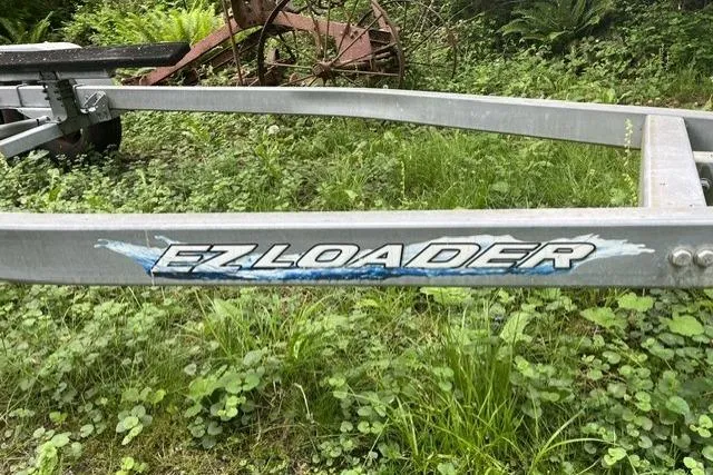 Slide: The Image of Trailer with "EZ Loader" logo in grassy area, compatible with 2008 Ranger 2510 Bay Ranger. - 13