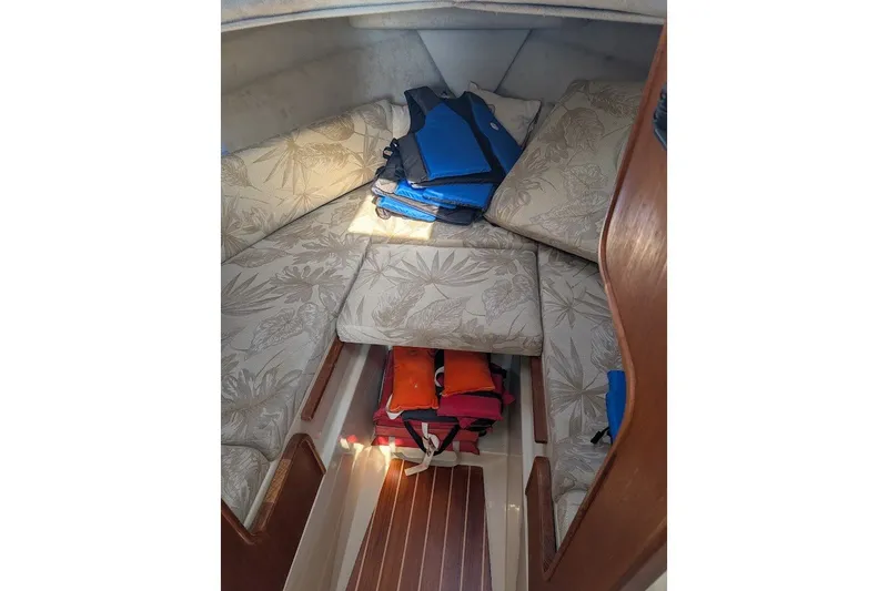 Slide: The Image of Interior cabin of 2008 Ranger 2510 Bay Ranger with floral cushions and life jackets. - 41