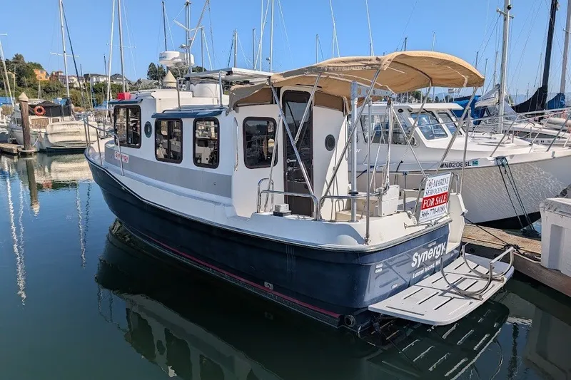 Slide: The Image of 2008 Ranger 2510 Bay Ranger boat docked, for sale sign visible. - 15