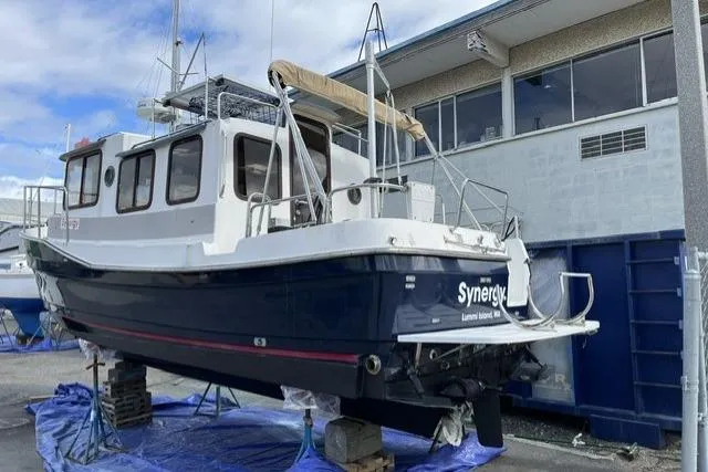 Slide: The Image of 2008 Ranger 2510 Bay Ranger boat on dry dock near a building. - 7